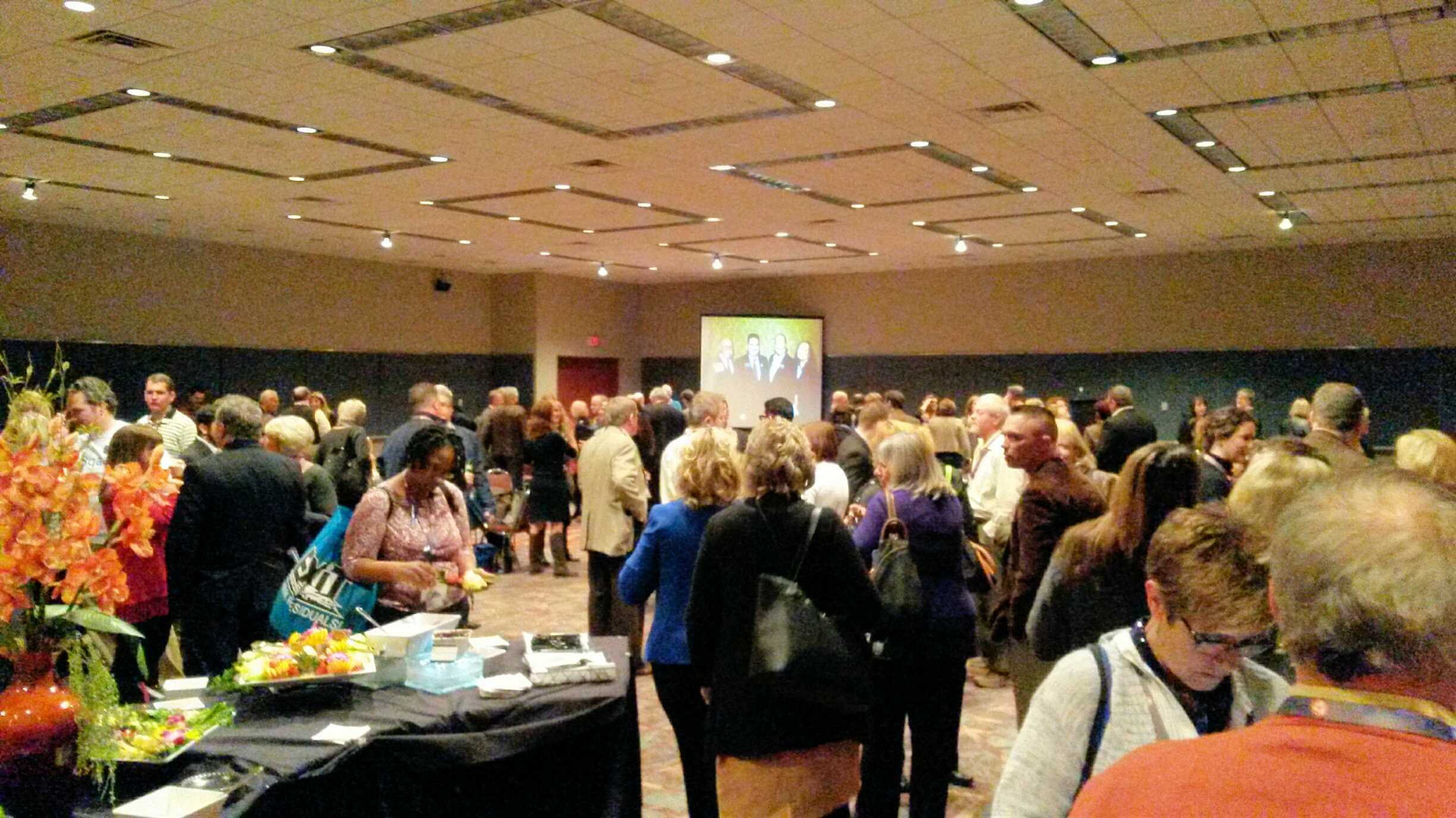 A group of professionals networking and snacking at the convention