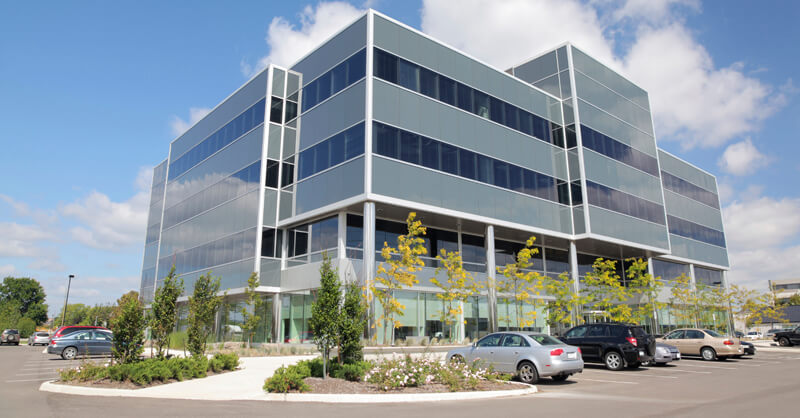 view from the parking lot of a modern multi-story office building