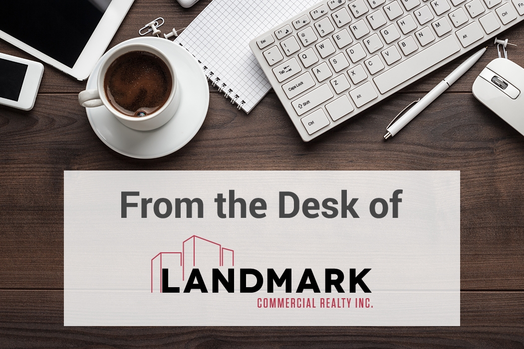 From the Desk of Landmark Commercial Realty Inc. graphic with office desk setup including coffee, keyboard, notebook, pen, and smartphone—representing professional real estate communication.