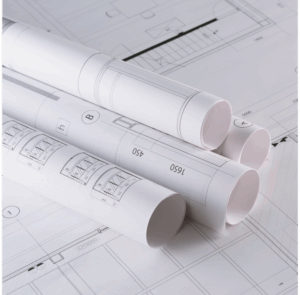 pile of rolled-up architectural plans on paper