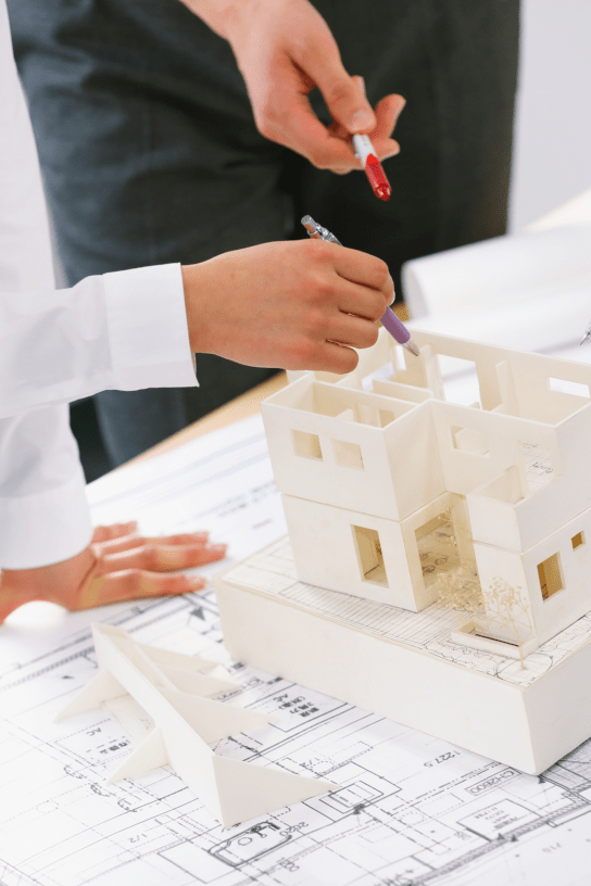 stock image of business professionals reviewing architectural plans
